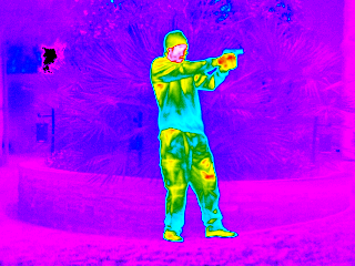 Rainbow color thermal image of man with a pistol handgun