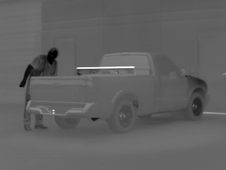 Black hot thermal image of suspect approaching pick up truck toolbox