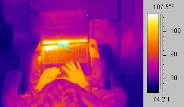 A thermal image of a dude hiding behind a laptop