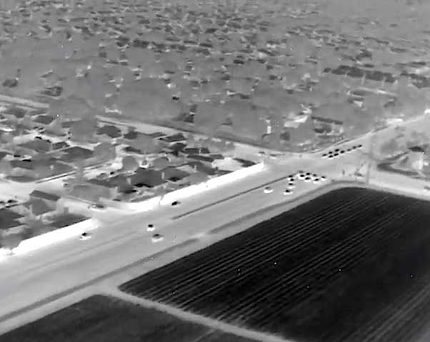 Airborne UAV FLIR thermal image of agricultural crops and suburban sprawl.