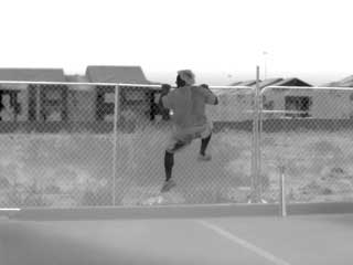 A thermal image of a man trying to hop a fence