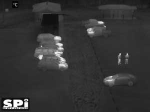 Monochrome white hot FLIR UAV security image of a parking lot