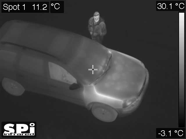 thermal image of a person peeping in a car window